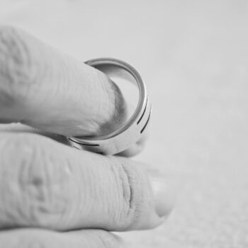 man holding ring contemplating divorce